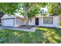 Exterior view showcasing a well-kept lawn, complemented by a sturdy front door and neat landscaping at 978 S Salida St, Aurora, CO 80017