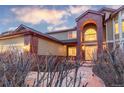 Beautifully designed home featuring a brick entrance arch, garage, and a serene yard at 10645 Clarkeville Way, Parker, CO 80134