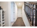 Hallway with hardwood floors, staircase, and white paneled doors create a welcoming ambiance at 11830 W 52Nd Ave, Wheat Ridge, CO 80033