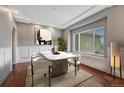 Bright dining room features a marble table, modern art, and an abundance of natural light from a large window at 7170 Windwood Way, Parker, CO 80134