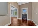 View of the entryway with hardwood floors, a windowed door, and white trim details at 7170 Windwood Way, Parker, CO 80134