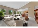 Inviting living room with an open layout to the kitchen and large windows at 7170 Windwood Way, Parker, CO 80134