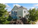 Charming home exterior with a colorful two-tone design surrounded by lovely landscaping at 2856 Shadow Lake Rd, Lafayette, CO 80026