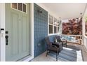 Inviting front porch with comfortable seating and a hanging swing, perfect for relaxing and enjoying the outdoors at 2856 Shadow Lake Rd, Lafayette, CO 80026