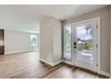 The entryway features a glass panel front door and sidelight, seamlessly connecting the interior with the outdoors at 3420 N Steele St, Denver, CO 80205