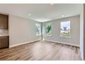 Living room bathed in natural light from three windows, creating a bright and airy atmosphere at 3420 N Steele St, Denver, CO 80205