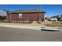 Spacious side yard featuring a wood fence and plenty of room for outdoor activities at 2003 Monte Vista Dr, Lochbuie, CO 80603