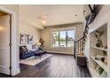 Cozy living room features dark wood floors, modern decor, and a staircase leading to the upper level at 2700 E Louisiana Ave # 203, Denver, CO 80210