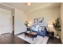 Comfortable living room with stylish furniture, dark hardwood floors, and contemporary wall art at 2700 E Louisiana Ave # 203, Denver, CO 80210