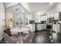 Modern kitchen with white cabinets, stainless steel appliances, and a breakfast nook at 3738 Rosewalk Ct, Highlands Ranch, CO 80129
