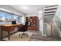 Home office with built-in shelving, a desk, and comfortable chair at 3738 Rosewalk Ct, Highlands Ranch, CO 80129