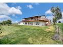 Spacious home with a wraparound deck and large yard perfect for outdoor living at 13080 County Road 19, Platteville, CO 80651