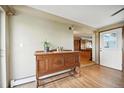 Foyer with hardwood floors and antique wood accent cabinet at 13080 County Road 19, Platteville, CO 80651