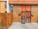 Close-up exterior of a tan townhome with secure front doors at 2895 S Locust St, Denver, CO 80222