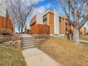 Multi-story townhome featuring brick facade and professional landscaping at 2895 S Locust St, Denver, CO 80222