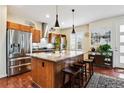 Modern kitchen with stainless steel appliances and a central island with barstool seating at 3379 Cranston Cir, Littleton, CO 80126