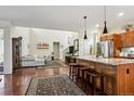 Open-concept living room and kitchen featuring hardwood floors and modern decor at 3379 Cranston Cir, Littleton, CO 80126