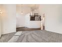 Bright, airy living room with neutral carpet, staircase and a high ceiling, perfect for Gathering gatherings at 270 Terra Vista St, Brighton, CO 80601