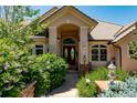 Inviting home exterior featuring a grand entrance and landscaping at 10010 Steeplechase Dr, Franktown, CO 80116