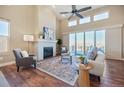 Inviting living room featuring a fireplace, high ceilings, and sliding glass doors to a balcony at 775 Woodgate Dr, Highlands Ranch, CO 80126