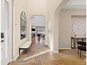 Welcoming foyer with tile flooring and views into the living spaces at 9581 Firenze Way, Highlands Ranch, CO 80126