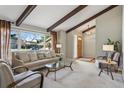 Bright living room featuring large windows, exposed beams, neutral color palette and comfortable seating at 4967 E Lake Ave, Centennial, CO 80121