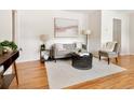 Bright living room with hardwood floors and a cozy seating area at 6223 Gray St, Arvada, CO 80003