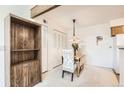 Dining room area with a bright light fixture provides a cozy ambiance for meals near the built in shelving at 10251 W 44Th Ave # 3-204, Wheat Ridge, CO 80033