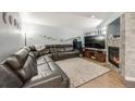 Spacious living room with a cozy fireplace, comfortable seating, and plenty of room to relax at 13275 Holly St # E, Thornton, CO 80241