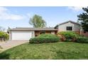 Charming single-story home featuring a well-maintained lawn, brick accents, and an attached two-car garage at 3322 Simms St, Wheat Ridge, CO 80033