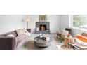 Cozy living room with a stone fireplace, plush seating, and bright natural light at 3322 Simms St, Wheat Ridge, CO 80033