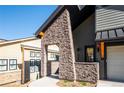 Inviting entryway with stone pillars leading to the front door of the house at 3909 Piney Grove St, Evergreen, CO 80439