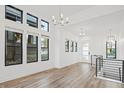 Bright, airy living room with large windows and modern light fixtures, showcasing sleek design at 3909 Piney Grove St, Evergreen, CO 80439