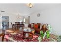 Bright dining area with hardwood floors and a chandelier at 19813 E 47Th Ave, Denver, CO 80249