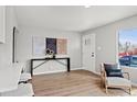 Stylish entry area with a console table and sleek decor, complemented by natural light and hardwood floors at 1601 S Zuni St, Denver, CO 80223