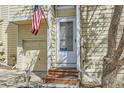 Close up of the front door, shows house number and the American flag at 12935 W 64Th Dr # D, Arvada, CO 80004