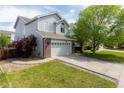 Attractive two-story home boasting a manicured lawn and a two car garage at 4715 E 127Th Dr, Thornton, CO 80241
