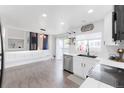 Open-concept kitchen and dining area with modern finishes and access to the deck at 4715 E 127Th Dr, Thornton, CO 80241