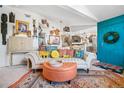 Bright living room featuring sofa, ottoman, and vibrant decor with view of the kitchen at 8653 E Dry Creek Rd # 1121, Englewood, CO 80112