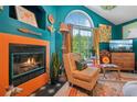 Cozy living room featuring a fireplace, eclectic decor, and a comfortable chair by a window at 8653 E Dry Creek Rd # 1121, Englewood, CO 80112