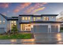 Modern home featuring a three-car garage, stone accents, and covered front porch at 303 Rogers Ct, Castle Rock, CO 80104