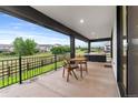 Outdoor patio with dining table and chairs overlooking backyard at 303 Rogers Ct, Castle Rock, CO 80104
