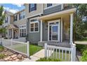 Inviting front porch with white columns and a walkway leading to the front door at 1484 Nemrick Pl, Castle Rock, CO 80109