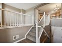 Elegant staircase with white railings and carpeted steps leading to the upper level at 1484 Nemrick Pl, Castle Rock, CO 80109