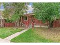 Charming brick home with a cozy front porch and well-maintained lawn surrounded by mature trees at 1457 S Franklin St, Denver, CO 80210