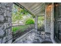 Inviting stone porch with iron railing, hanging plants, and cozy seating area perfect for relaxing outdoors at 4570 Irving St, Denver, CO 80211