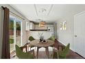 Cozy dining area featuring a round table, stylish chairs, and sliding glass doors to the backyard at 19721 E Vassar Ave, Aurora, CO 80013