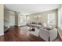 Bright living room featuring hardwood floors, neutral decor, and large windows for ample natural light at 19721 E Vassar Ave, Aurora, CO 80013
