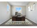 Dedicated home office space featuring a modern desk, neutral walls, and a comfortable work environment at 19721 E Vassar Ave, Aurora, CO 80013
