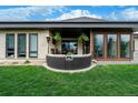 Spacious back patio featuring a cozy seating area, outdoor dining space, and beautiful landscaping at 6 Wilder Ln, Littleton, CO 80123